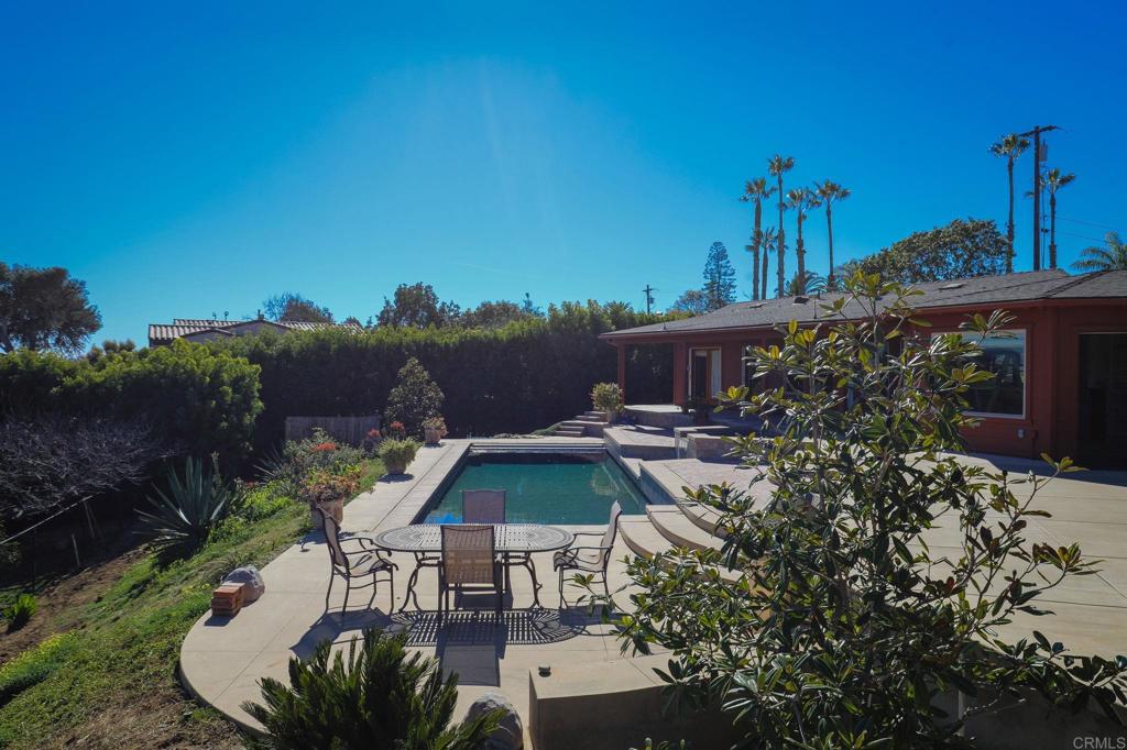 1575 Crest Drive Encinitas, CA 92024 - Photo 19 of 52 a view of a patio with furniture and a garden