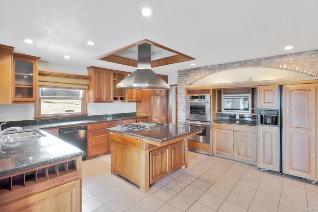1575 Crest Drive Encinitas, CA 92024 - Photo 24 of 52 a kitchen with stainless steel appliances granite countertop a stove and a sink