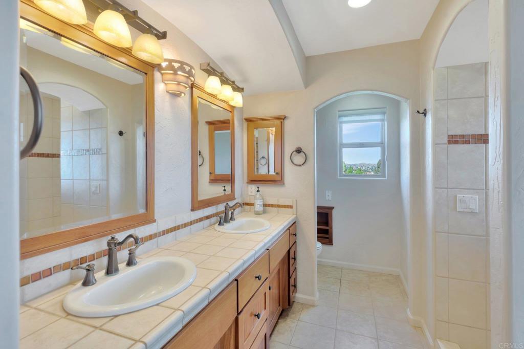 1575 Crest Drive Encinitas, CA 92024 - Photo 31 of 52 a bathroom with a sink and a mirror