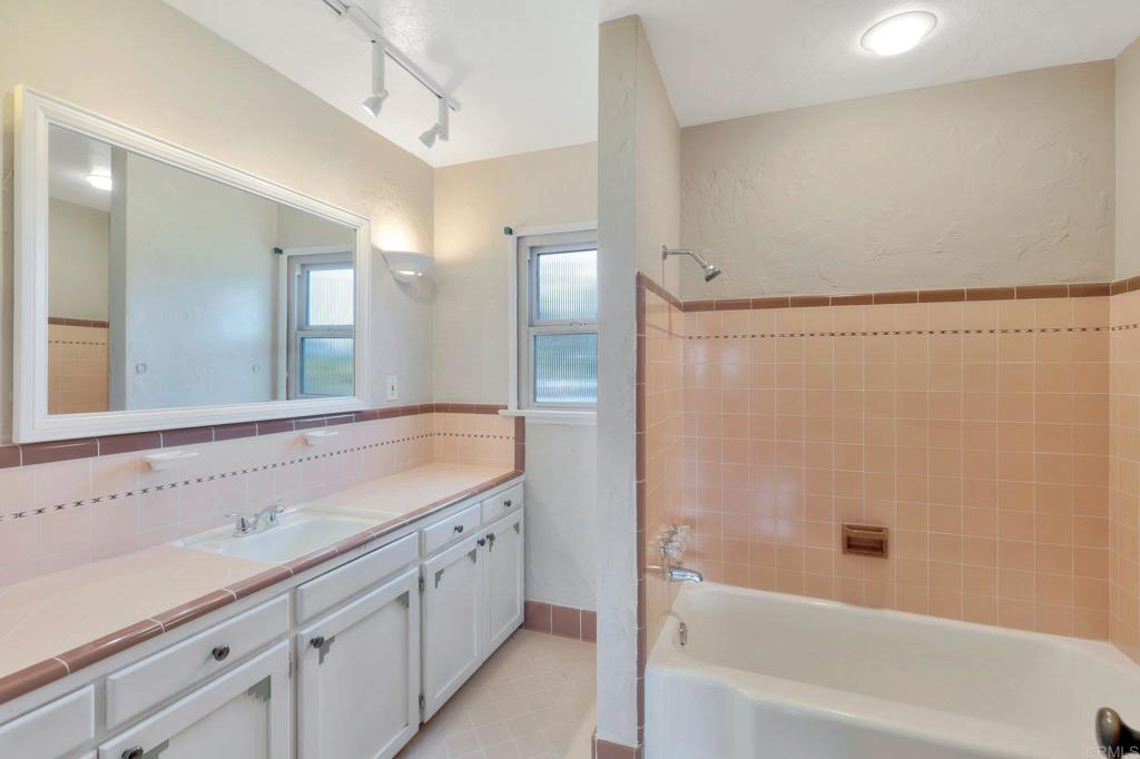 1575 Crest Drive Encinitas, CA 92024 - Photo 46 of 52 a bathroom with a bathtub and a sink