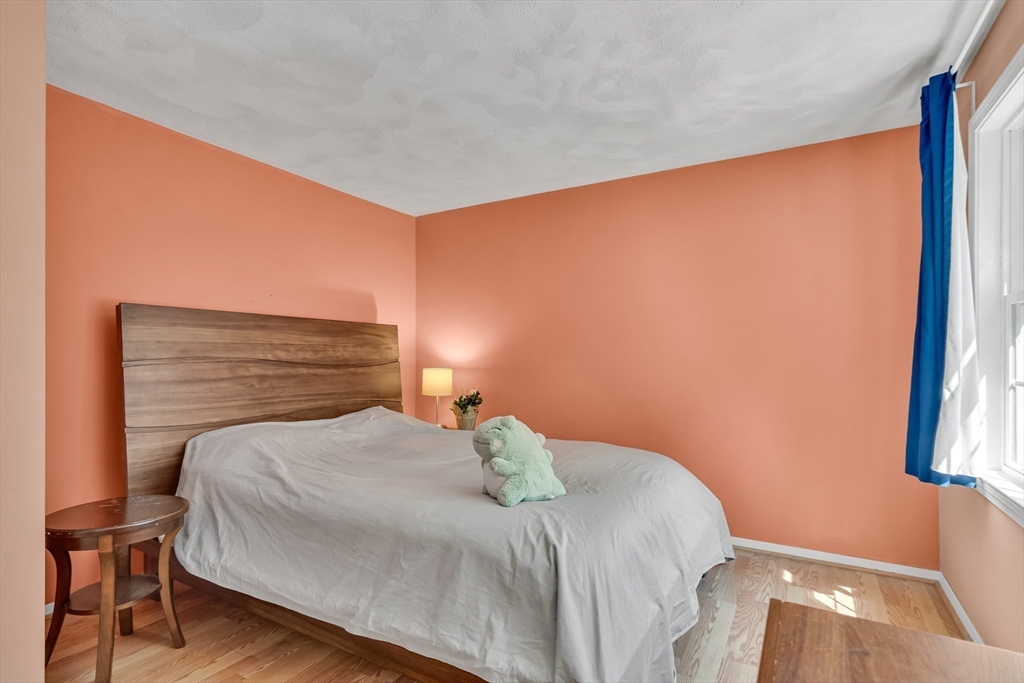 58 MacIntosh Lane, Unit 58 Boxborough, MA 01719 - Photo 16 of 23 a bedroom with a bed and a window