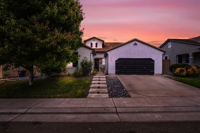 a front view of a house with a yard
