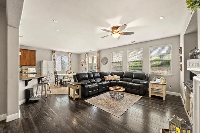 a living room with furniture a fireplace and a flat screen tv