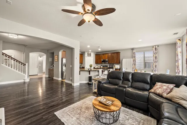 a kitchen with stainless steel appliances kitchen island granite countertop a refrigerator and cabinets