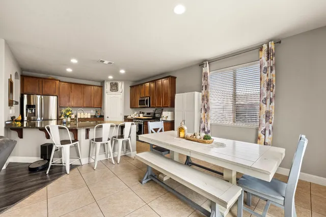 a kitchen with stainless steel appliances granite countertop a refrigerator sink and stove