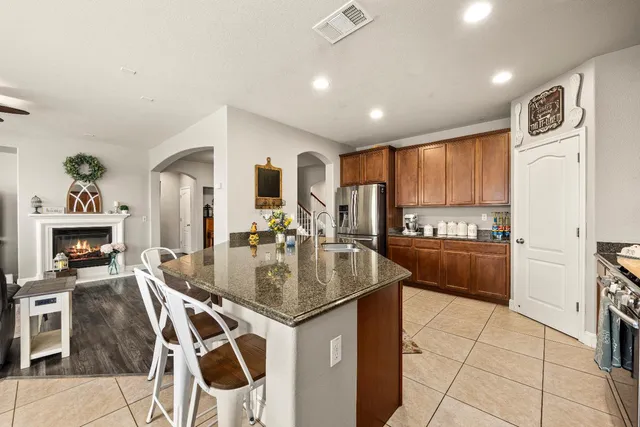 a kitchen with stainless steel appliances granite countertop a sink and a granite counter tops
