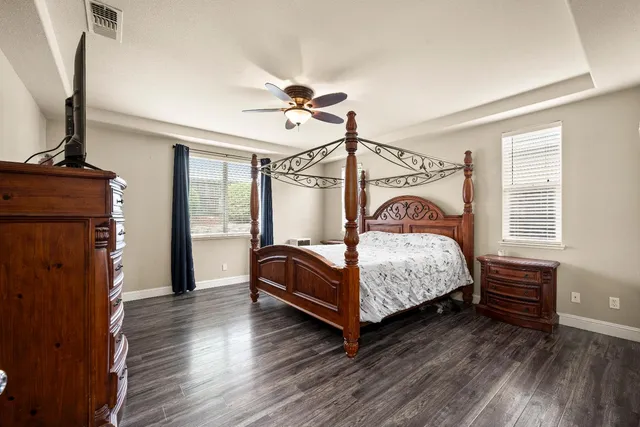 a bedroom with a bed closet and flat tv screen