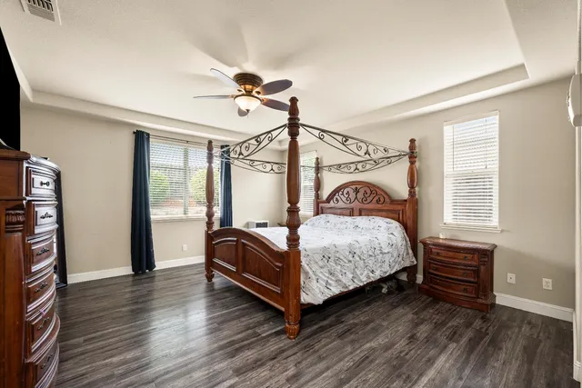 a spacious bathroom with a double vanity sink a large mirror and a shower