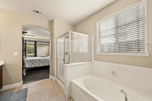 a bathroom with a sink a mirror and a shower