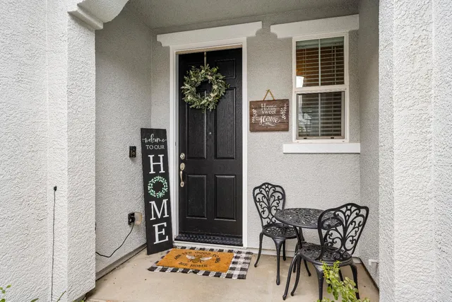 a backyard of a house with table and chairs