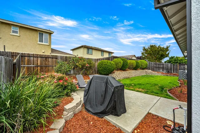 a building outdoor space with patio furniture and potted plants
