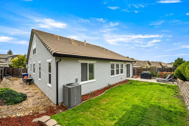 an aerial view of a house with balcony and garage