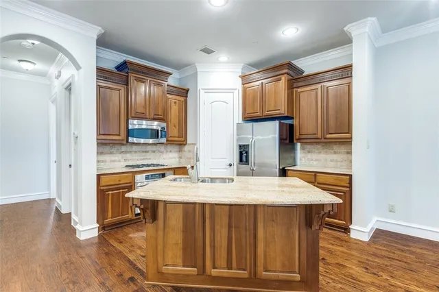 a kitchen with a wooden floor and a refrigerator