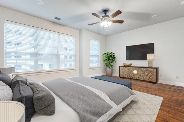 a bedroom with a large bed and a tv