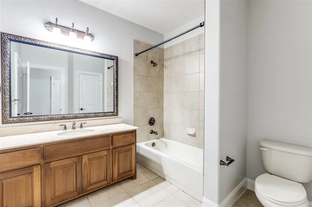 a bathroom with a tub sink toilet and mirror