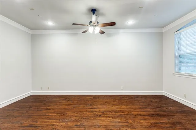 a view of a room with wooden floor window and a ceiling fan