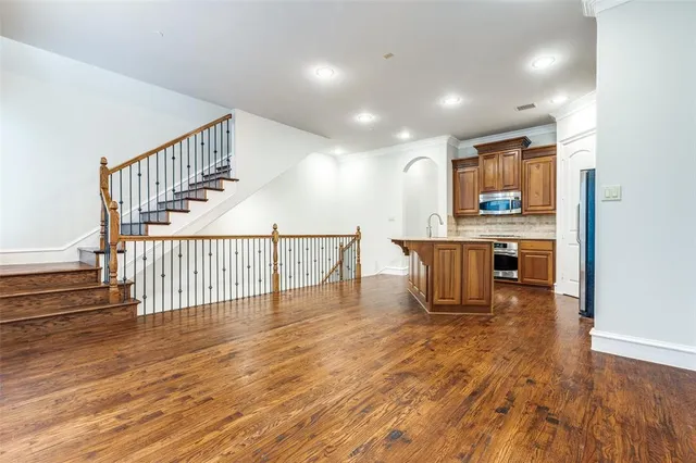 a view of a room with wooden floor and staircase