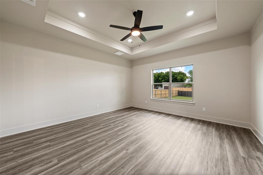 138 Dana Pt Road Lorena, TX 76655 - Photo 11 of 24 Spacious room featuring wood-finish flooring, a tray ceiling, recessed lighting, and a modern ceiling fan
