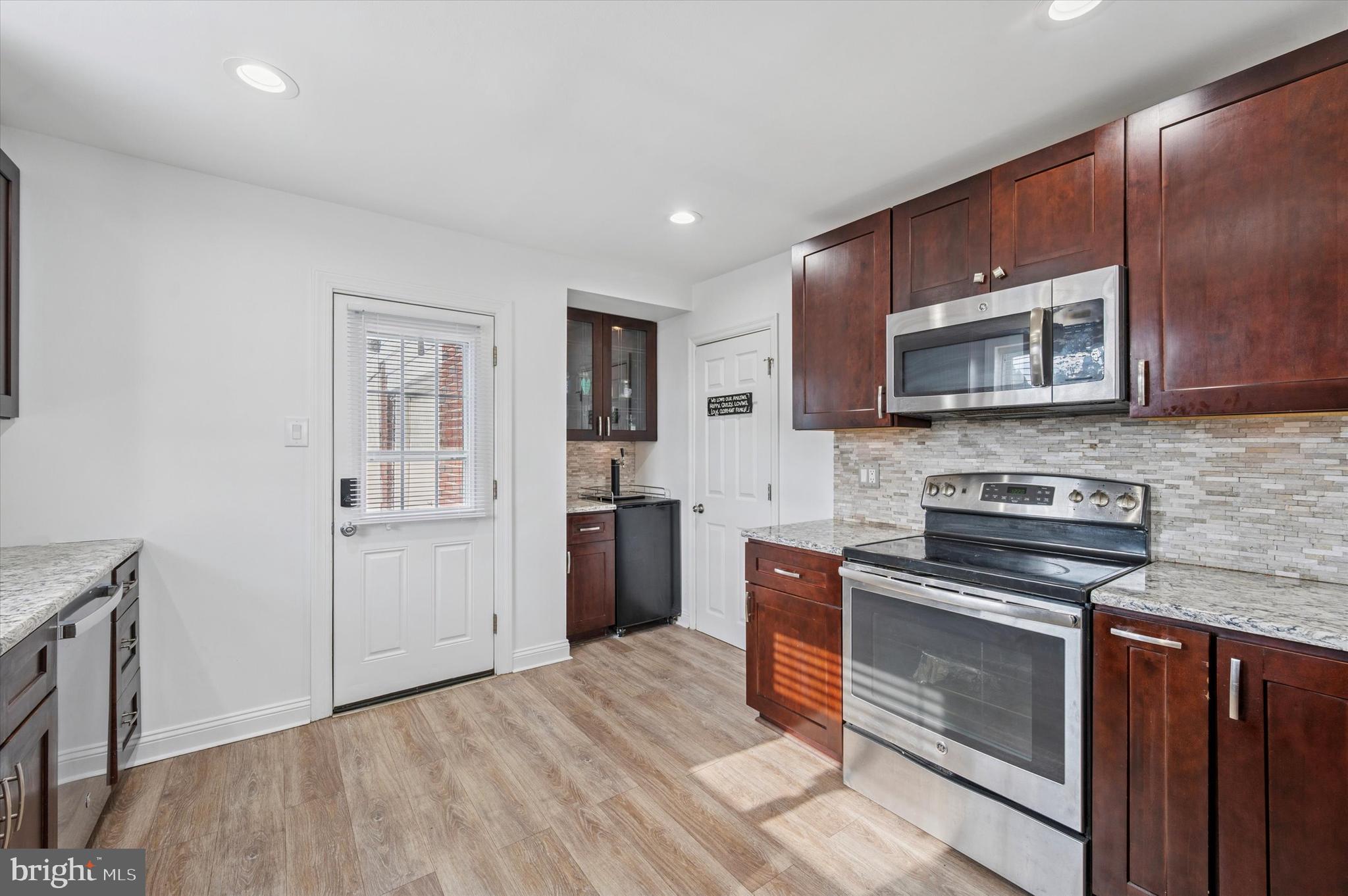 24 Upland Road Havertown, PA 19083 - Photo 13 of 28 a kitchen with stainless steel appliances granite countertop a stove microwave and sink