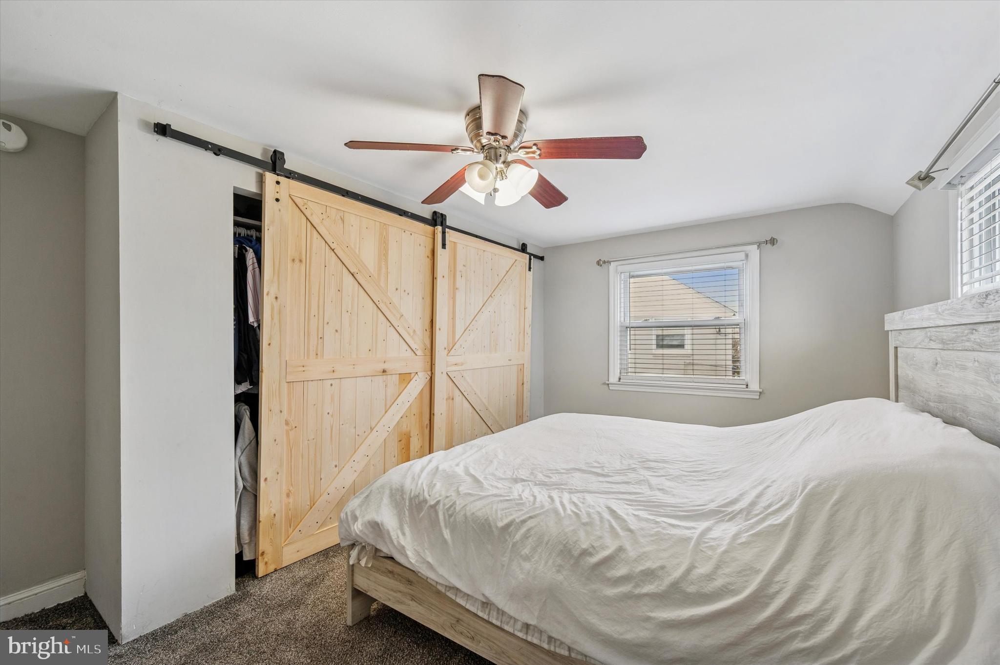 24 Upland Road Havertown, PA 19083 - Photo 17 of 28 a bedroom with a bed and a chandelier