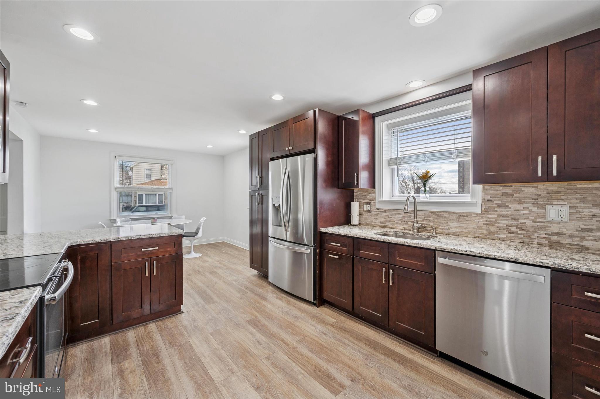 24 Upland Road Havertown, PA 19083 - Photo 8 of 28 a kitchen with stainless steel appliances granite countertop a sink stove and refrigerator