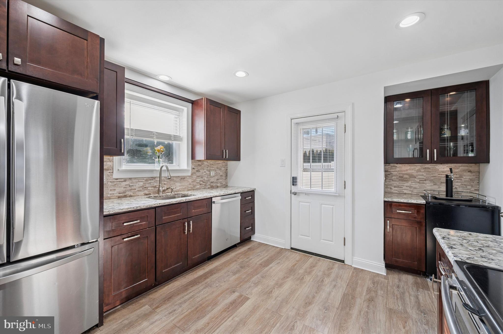 24 Upland Road Havertown, PA 19083 - Photo 10 of 28 a kitchen with stainless steel appliances granite countertop a refrigerator and a stove top oven