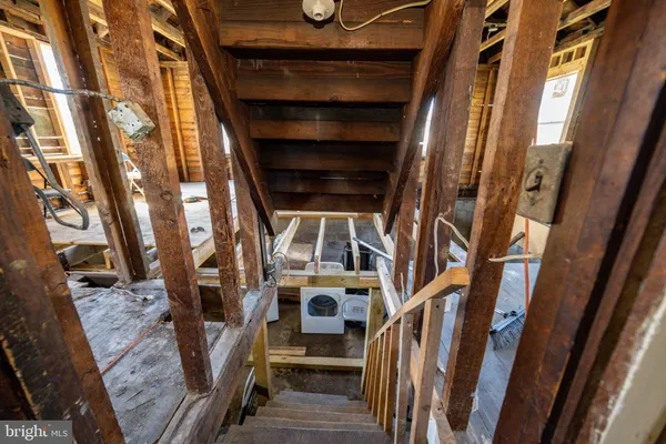 a view of a room with wooden floor and windows