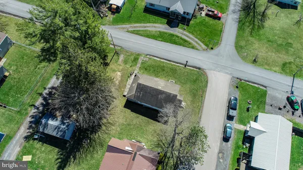 an aerial view of a house with a garden and trees