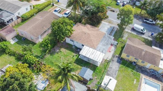 an aerial view of a house with garden space and street view