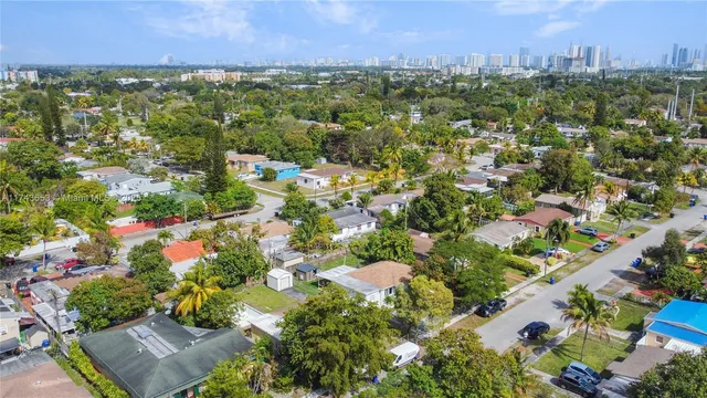 an aerial view of residential house with outdoor space and trees all around