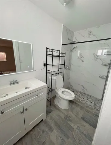 a bathroom with a toilet sink and shower