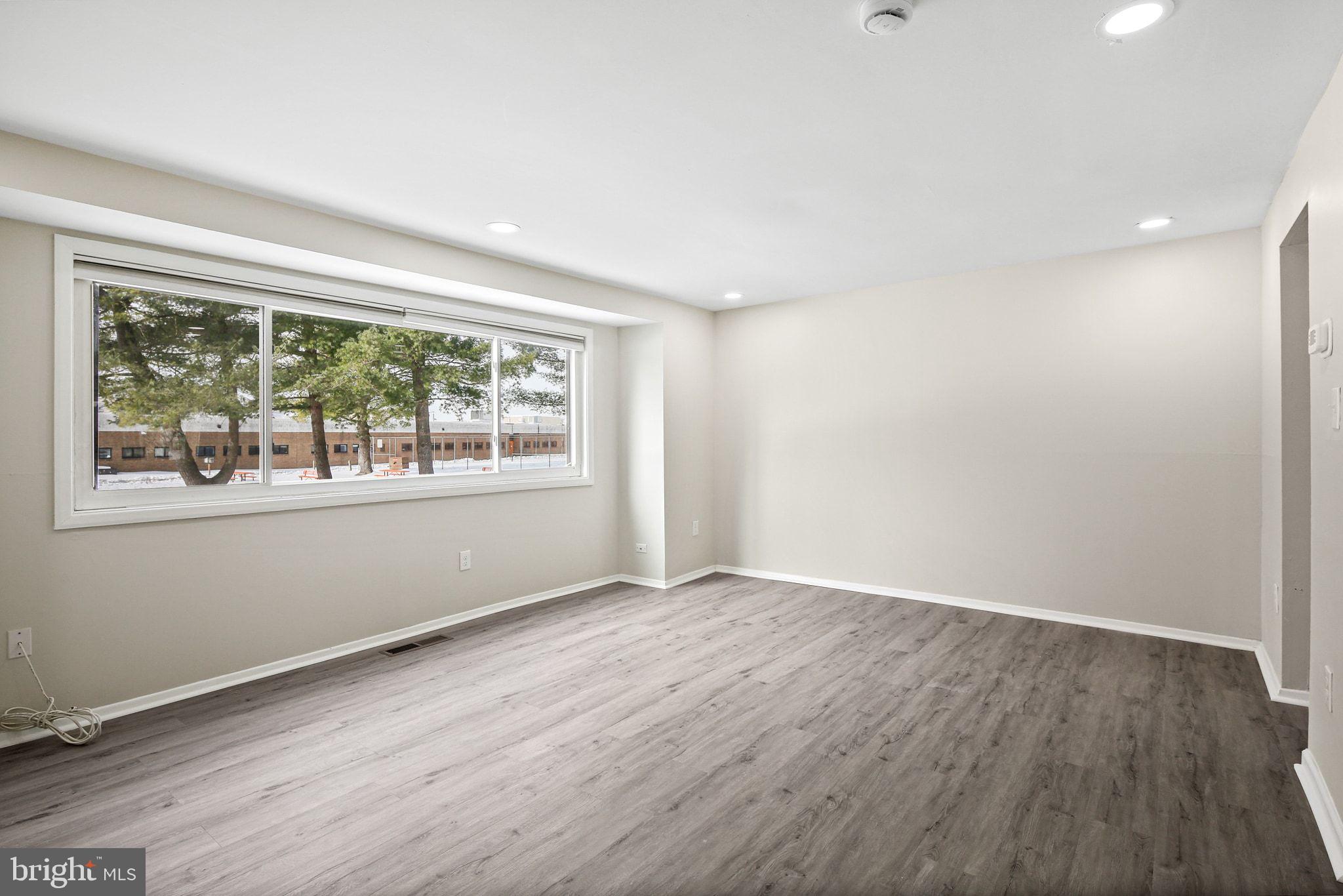 9411 Merryrest Road, Unit B Columbia, MD 21045 - Photo 7 of 25 Light-filled living area w/ LVP floors