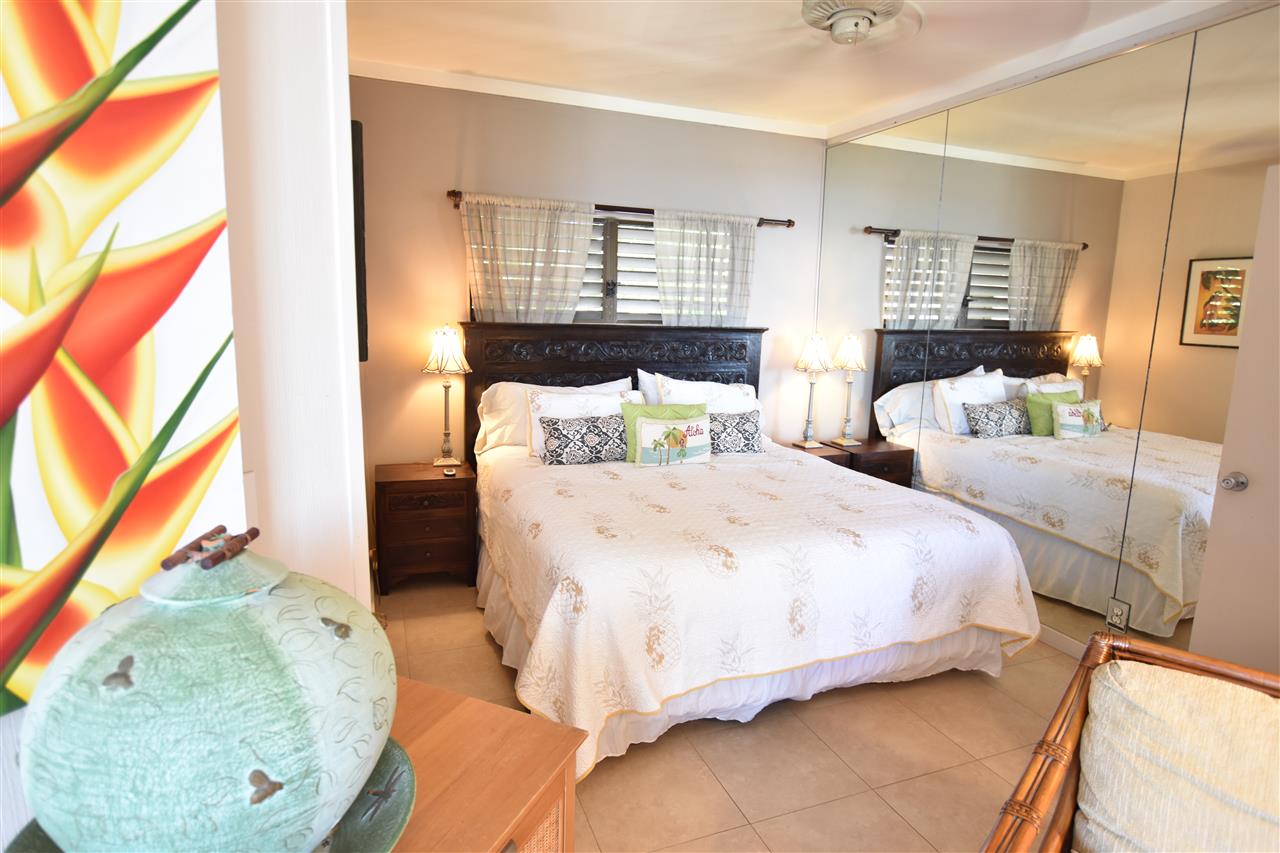 4435 Lower Honoapiilani Road, Unit 204 Lahaina, HI 96761 - Photo 11 of 23 a bedroom with a bed and a mirror