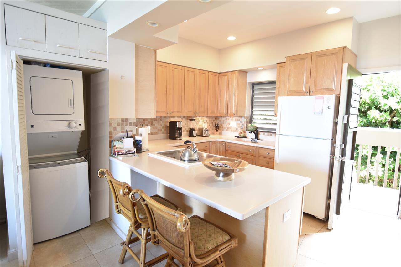 4435 Lower Honoapiilani Road, Unit 204 Lahaina, HI 96761 - Photo 14 of 23 a kitchen with a sink a refrigerator and a stove