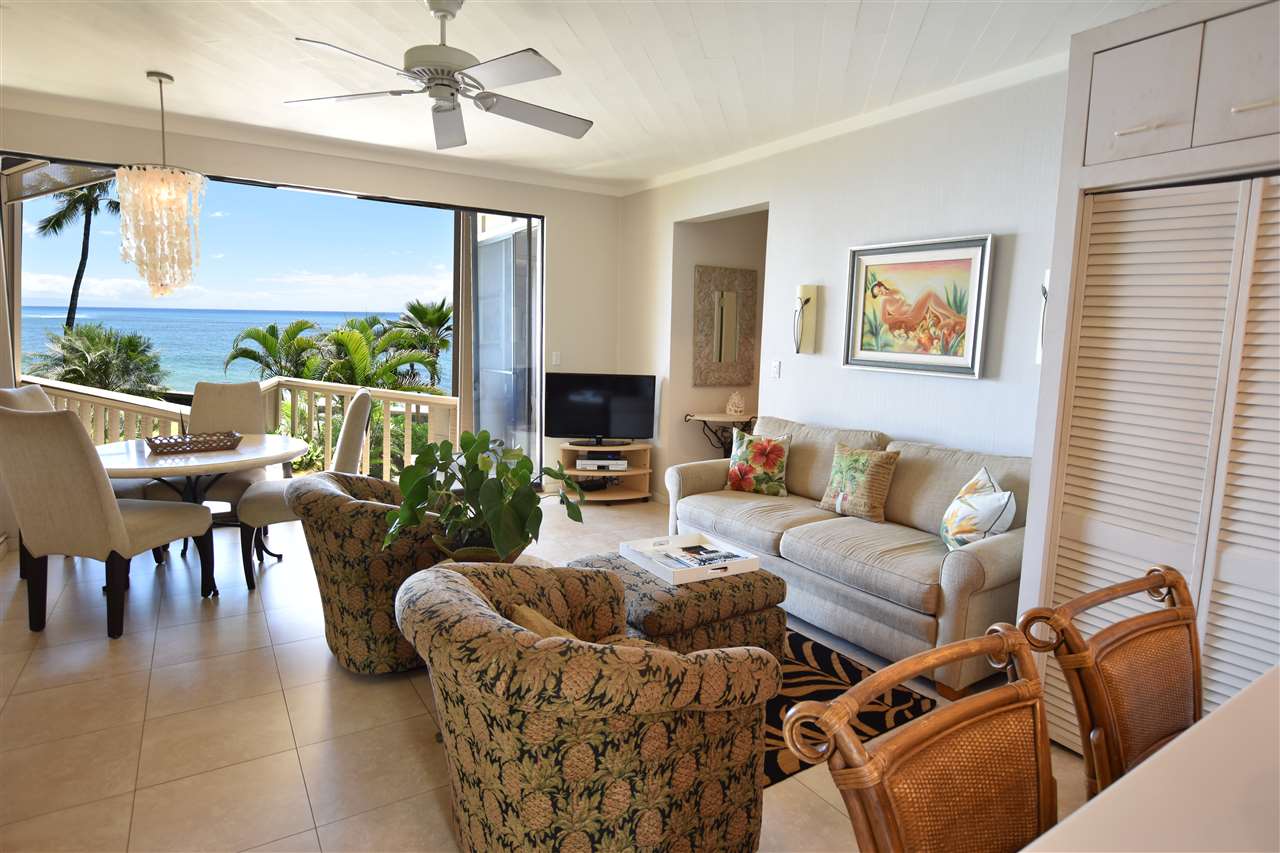 4435 Lower Honoapiilani Road, Unit 204 Lahaina, HI 96761 - Photo 5 of 23 a living room with furniture and a floor to ceiling window