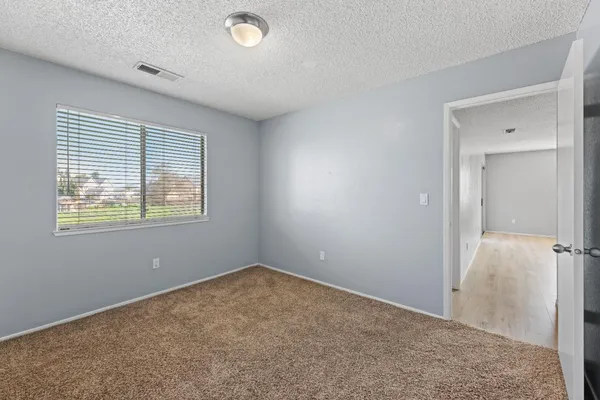 a view of an empty room with a window