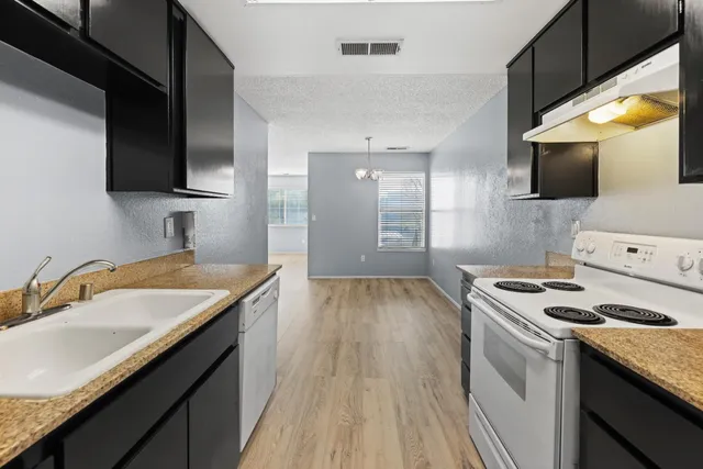 a kitchen with a sink stove and microwave