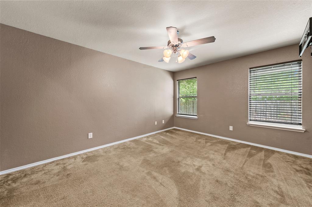 10512 Granada Drive Waco, TX 76708 - Photo 12 of 22 an empty room with windows and fan