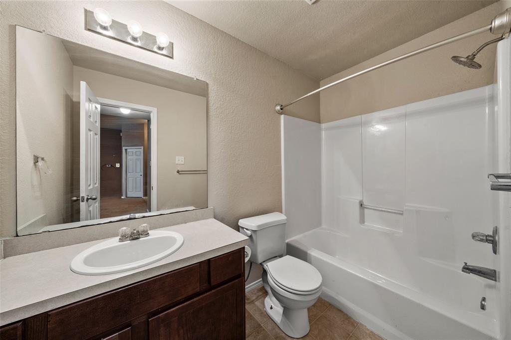 10512 Granada Drive Waco, TX 76708 - Photo 16 of 22 a bathroom with a sink a toilet and a bathtub
