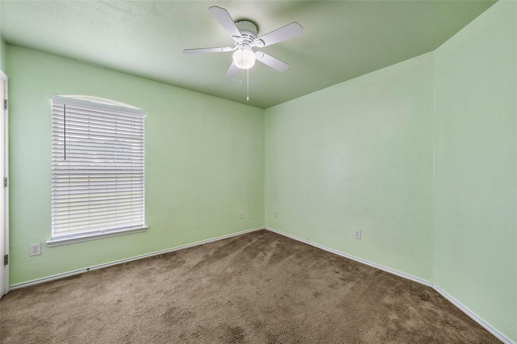 10512 Granada Drive Waco, TX 76708 - Photo 18 of 22 an empty room with a window and a fan