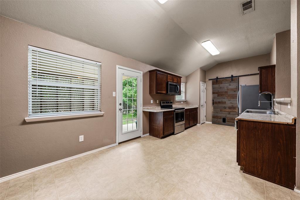 10512 Granada Drive Waco, TX 76708 - Photo 6 of 22 a large kitchen with cabinets and stainless steel appliances