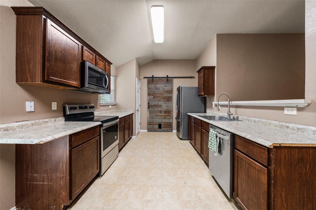 10512 Granada Drive Waco, TX 76708 - Photo 8 of 22 a large kitchen with stainless steel appliances granite countertop a stove refrigerator and a sink