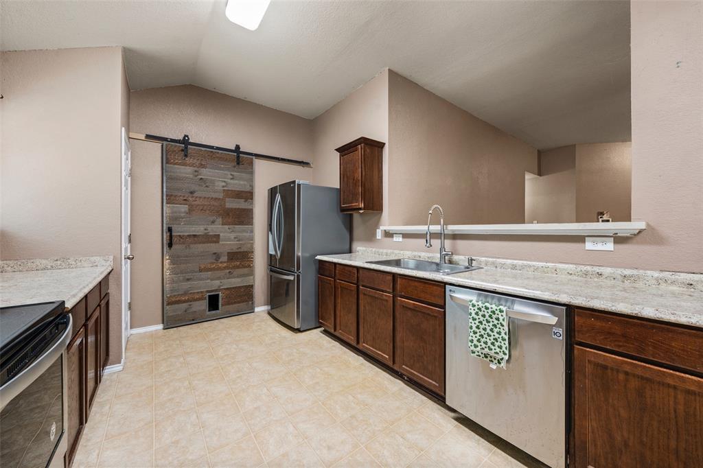 10512 Granada Drive Waco, TX 76708 - Photo 10 of 22 a kitchen with stainless steel appliances granite countertop a sink stove and refrigerator