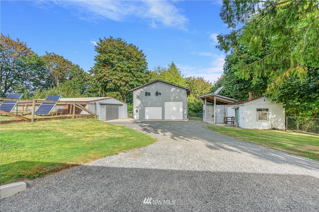 7023 Skipley Road Snohomish, WA 98290 - Photo 3 of 40 a front view of a house with a yard and garage