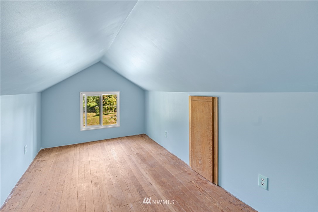 7023 Skipley Road Snohomish, WA 98290 - Photo 22 of 40 an empty room with a wooden floor and painting on the wall