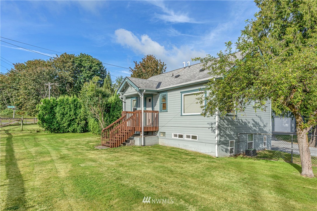 7023 Skipley Road Snohomish, WA 98290 - Photo 4 of 40 a view of a house with a backyard and a tree