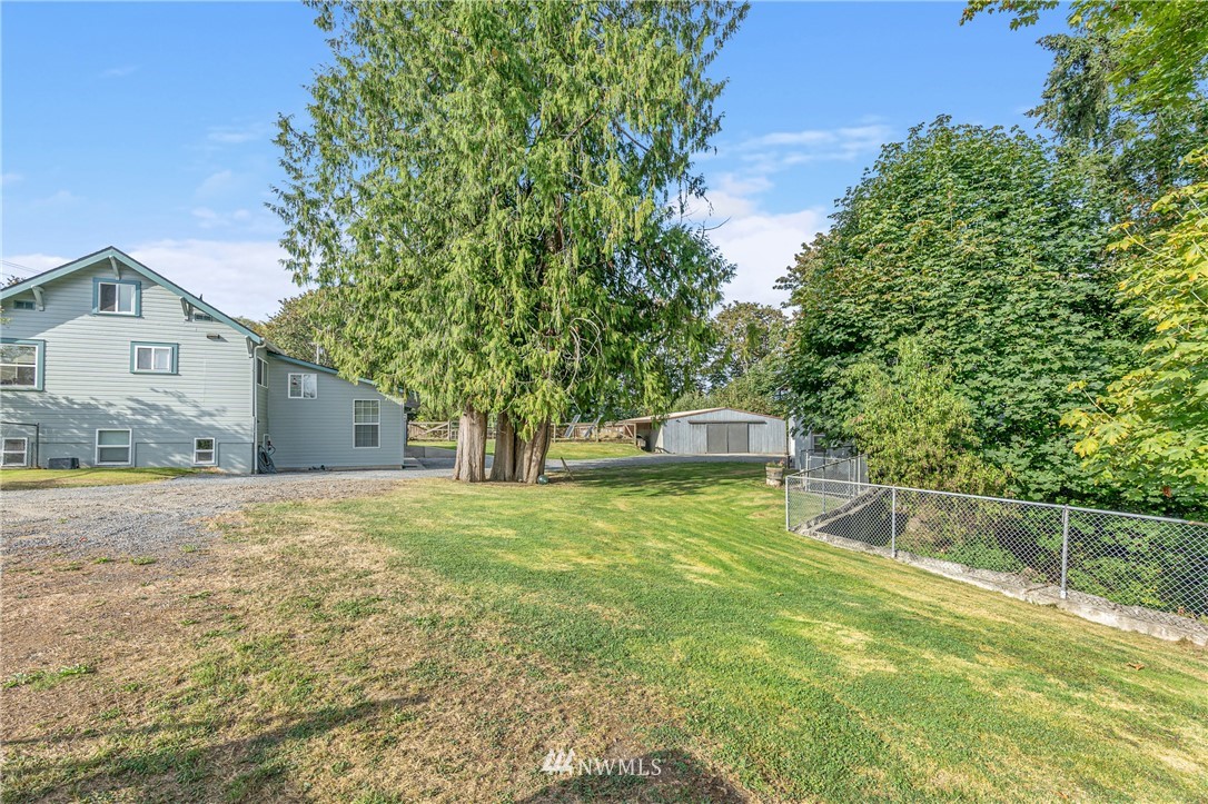 7023 Skipley Road Snohomish, WA 98290 - Photo 5 of 40 a front view of a house with a yard and garage