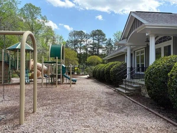 a view of a house with backyard porch and sitting area