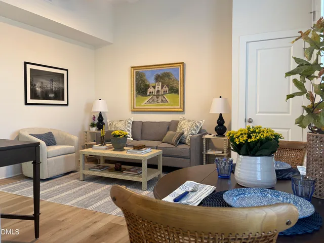 a living room with furniture and flowers