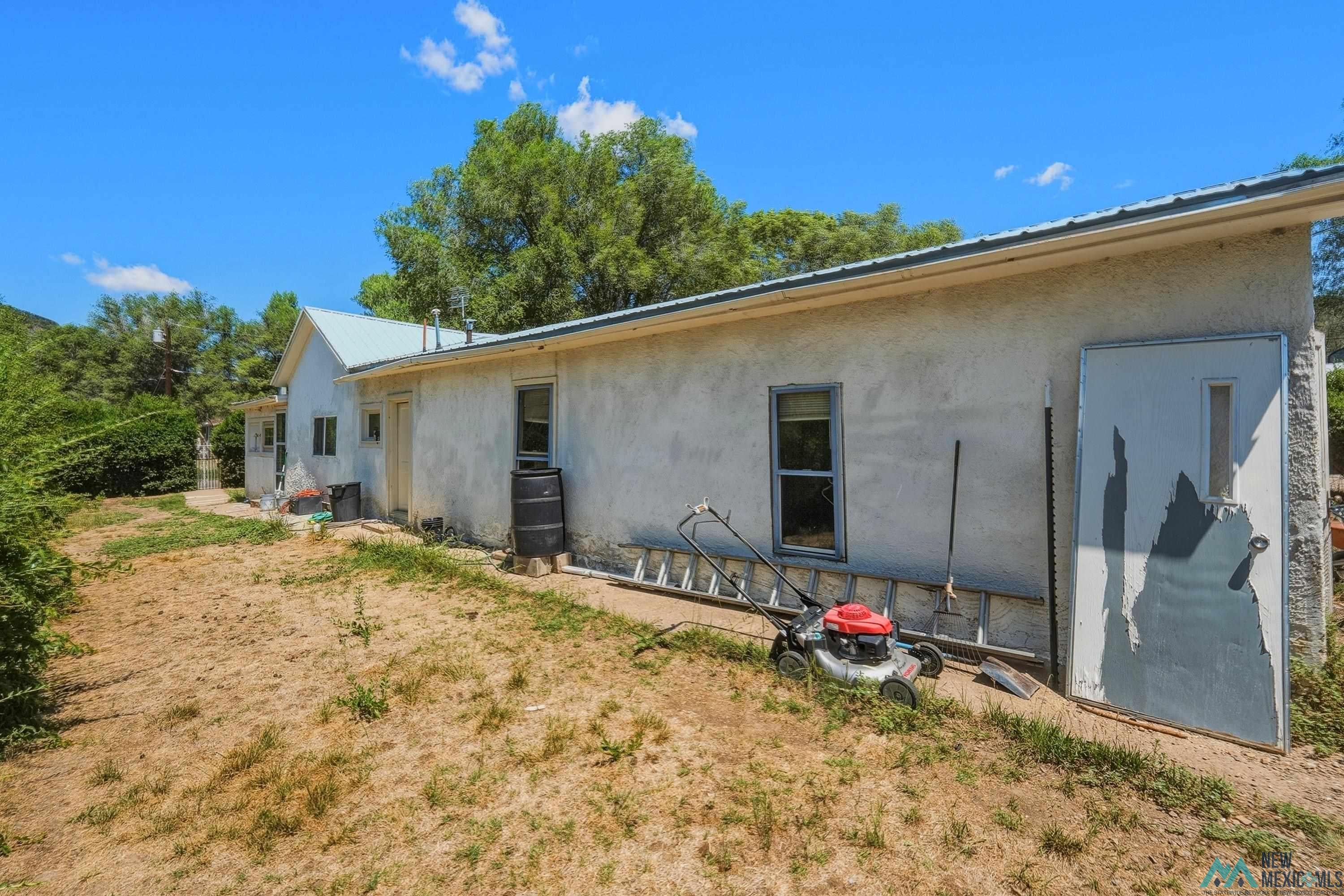 811 North 4th Street Raton, NM 87740 - Photo 19 of 26 Rear exterior with a pitched metal roofline